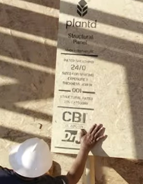 A construction worker positions and Plantd sheet featuring the DrJ and CBI logos. 